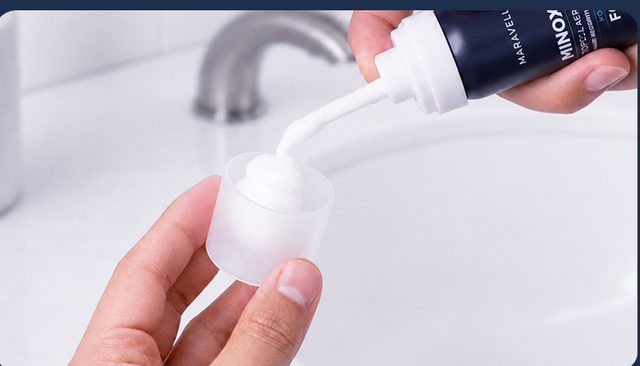 Dispensing minoxidil foam into the cap